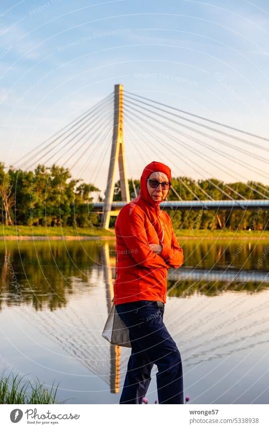 Woman standing in front of the pylon bridge over the Elbe near Schönebeck on the right bank of the river River River bank Right bank of the river Pylon bridge