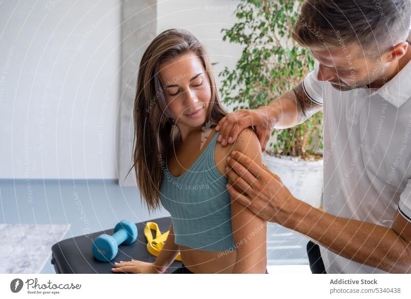 Man giving woman a shoulder massage Stock Photo