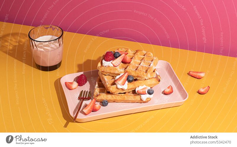 Waffles garnish with raspberry and blueberries waffle breakfast bakery blueberry homemade morning drink fruit colorful fork strawberry traditional