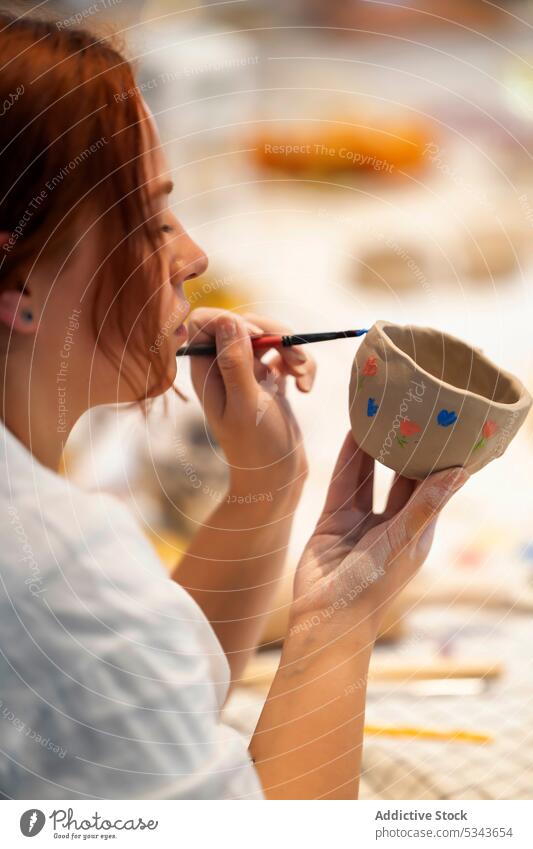 Crop woman decorating clay cup with paint pottery make ceramic artisan artist handmade craft studio craftswoman workshop female paintbrush young creative skill