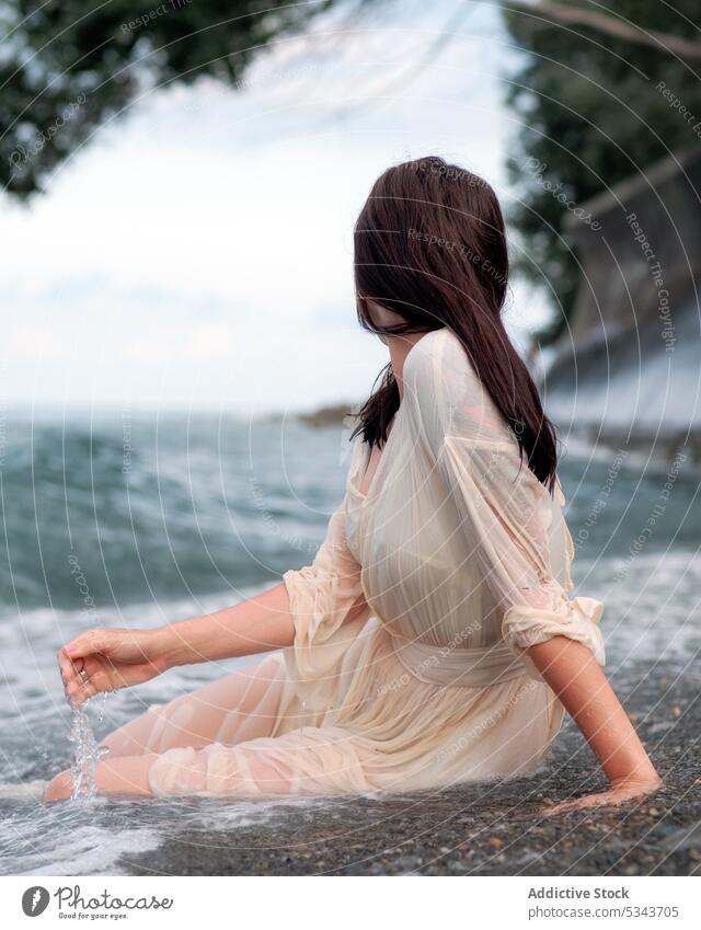 Woman in white dress near sea woman rest beach resort summer vacation relax holiday female coast ocean wave water shore enjoy travel nature necklace harmony