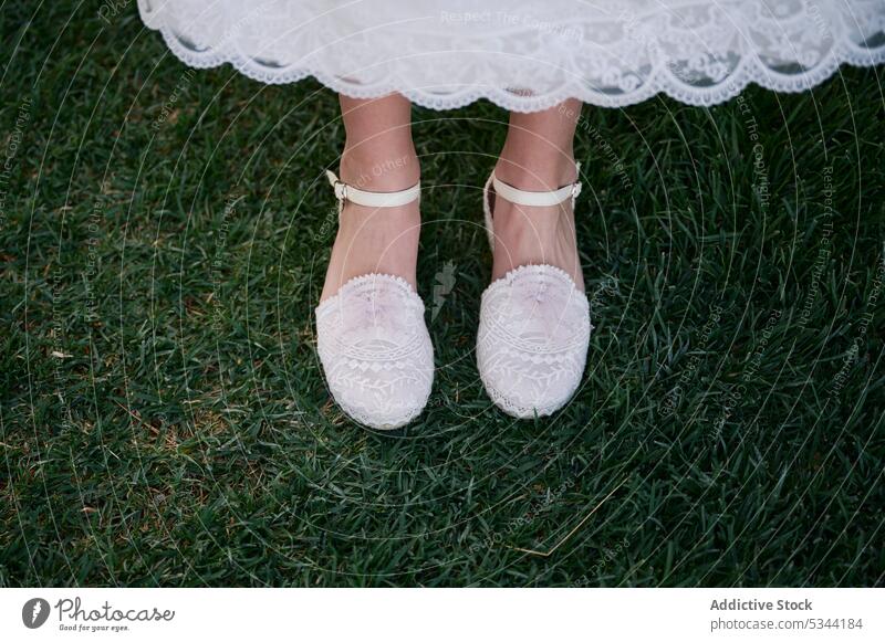 Legs of girl with shoes on grass in park lawn leg elegant child kid style nature dress footwear meadow grassy countryside summer fashion trendy field childhood