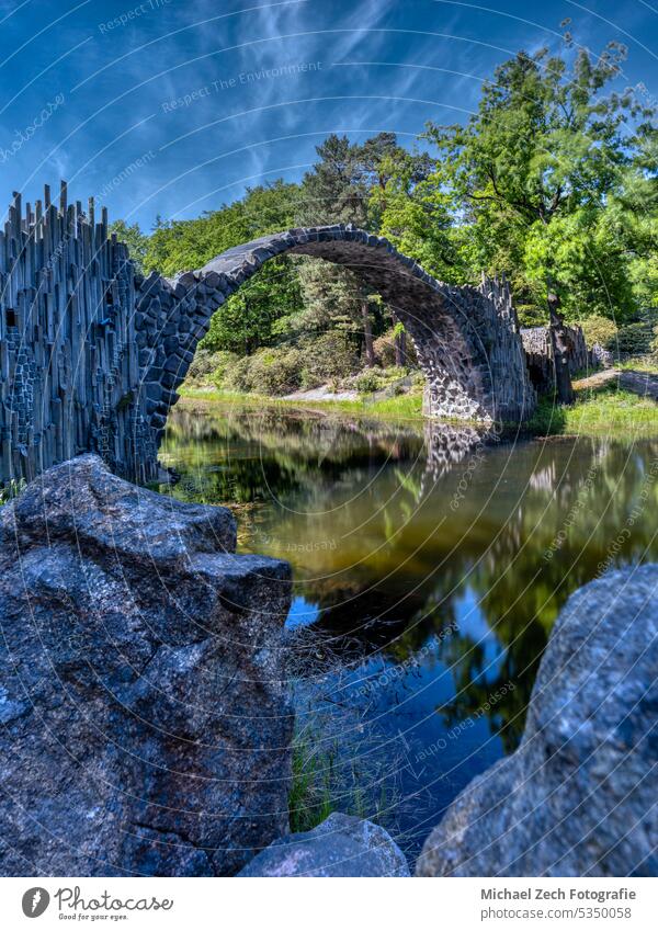 The Rakotz Bridge, also known as the Devil's Bridge, in Kromlau bridge germany nature landscape travel forest landmark lake water reflection kromlau park