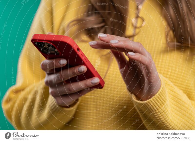 Hands of woman surfing internet on smartphone. Girl on blue background. adult app boy call carefree caucasian cellphone communication confidence connection