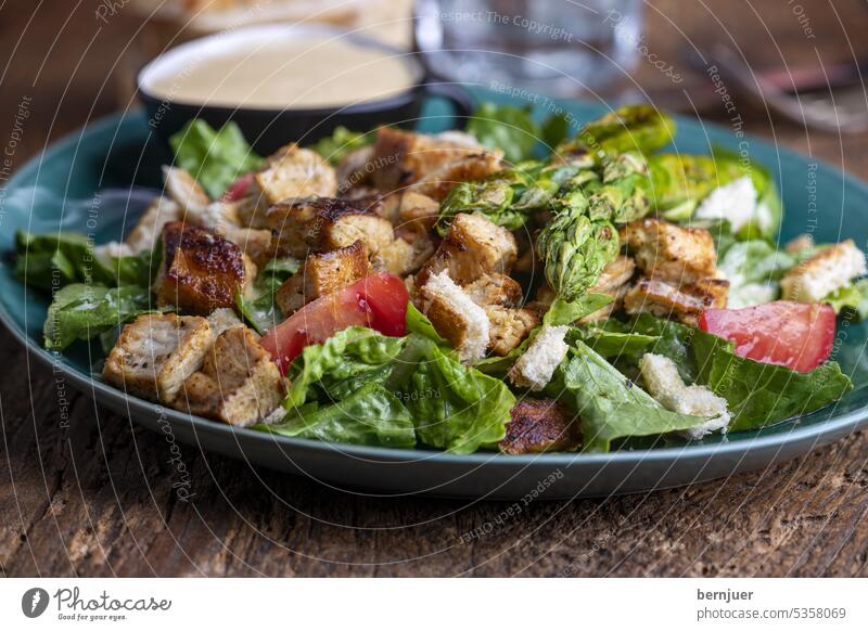 Caesar salad on a green plate Bread Fresh salubriously Meal Eating Dinner Green White Vegetable Plate Lettuce Lunch Appetizer Kitchen Diet grilled bowl sauce