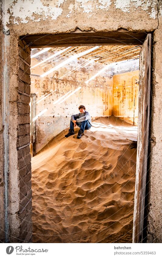 perched on sand Old Broken corrupted House (Residential Structure) Force of nature Sunlight Shadow decay Light Boy (child) Infancy Child Sand Ruin Ghost town