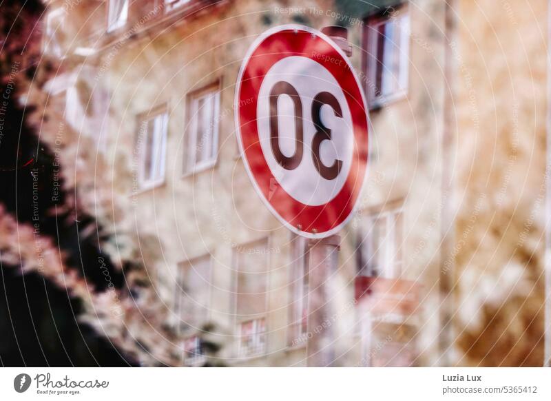 Speed limit 30... Sign and house facades reflected in a shop window tempo Road sign Street Transport Road traffic Motoring Signs and labeling Safety fasssade