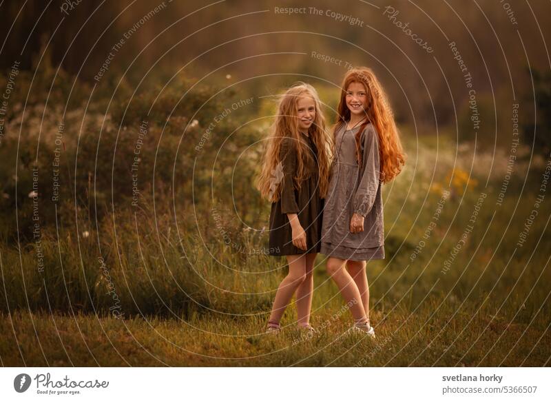 two friends, sisters with long hair in nature Love In love celebration Sunset green leaves wild nature Green nature Environment Landscape country Ecosystem
