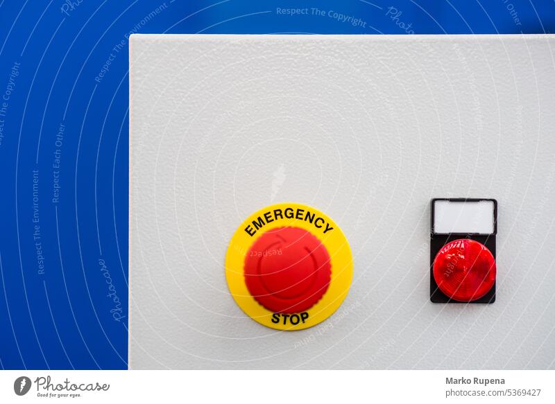 Red emergency stop button for stopping a machine in emergency situation switch safety technology push control alert off security panic industry warning danger