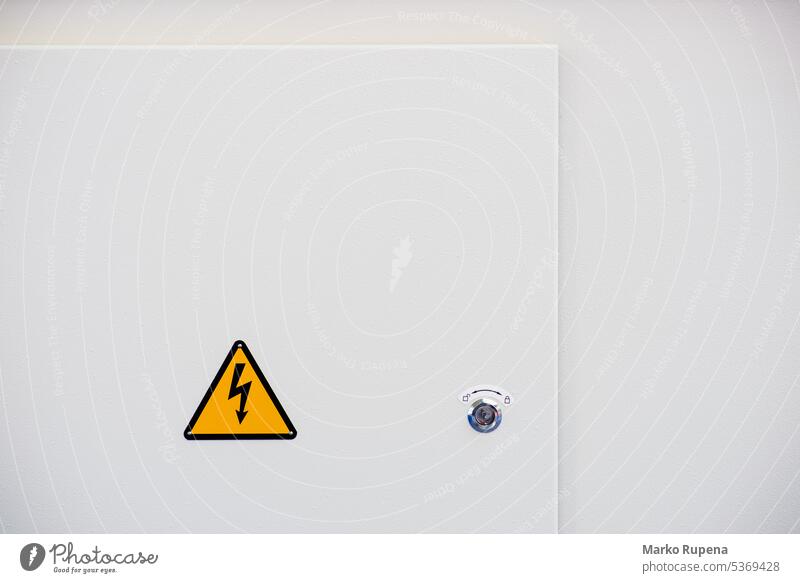 High voltage electrical hazard sign on a panel of a machine high voltage warning danger electricity arrow attention careful caution dangerous forbidden icon