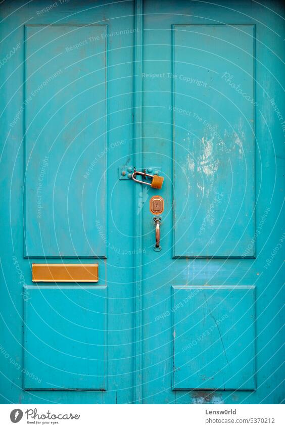 Turquoise wooden door with a padlock access control closed closed door closeup doorknob entrance gate keyhole old safe safety security turquoise vintage Detail