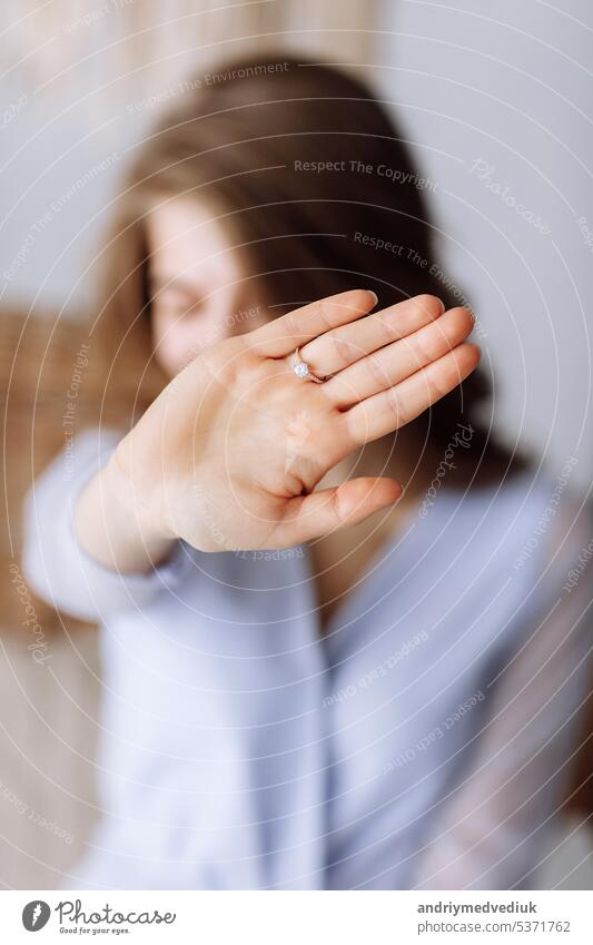 young woman shows a ring with diamond. The girl shows an engagement ring on her finger. she said yes. selective focus on hand. showing wedding female happy