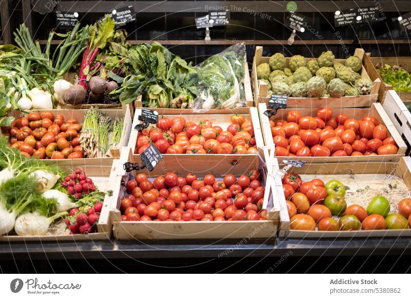 Assorted fresh vegetables in shop with price tags organic box tomato natural ripe sale market store product food retail ingredient assorted vegan grocery