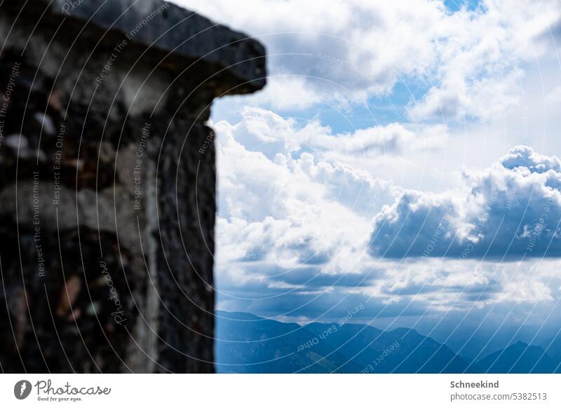 cheerful to cloudy Mountain mountains Hut Alpine hut Stone wall Cloudless sky Clouds in the sky Sun Light Blue sky blue sky with clouds Storm Storm warning