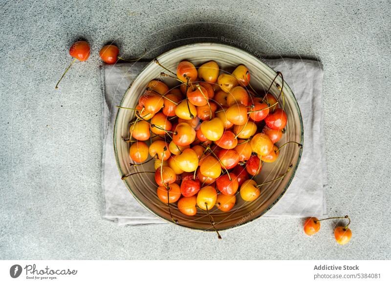 Sweet cherries in the bowl background berry cherry concrete dessert eat eating food fresh fruit grey healthy meal napkin organic red ripe seasonal summer sweet