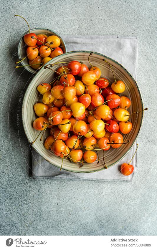 Sweet cherries in the bowl background berry cherry concrete dessert eat eating food fresh fruit grey healthy meal napkin organic red ripe seasonal summer sweet