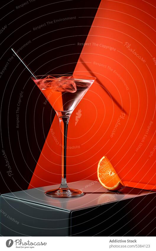 Generative AI illustration of fresh cocktail with ice cubes placed on table near slice of orange with straw alcohol drink refreshment summer glass delicious
