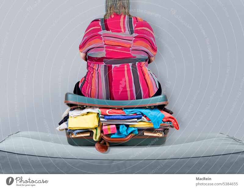 Travel preparation of an overweight Fat Overweight Suitcase go away pack a suitcase vacation Sofa sits Sit View from behind Concept image A human Woman