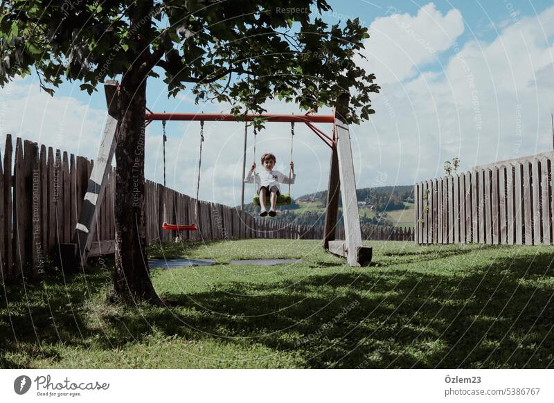 Child on the swing To swing Joie de vivre (Vitality) Joy Happy fortunate Contentment Playing Infancy Exterior shot Happiness Movement Swing fun Playground