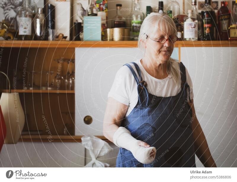 Mainfux |Woman with plaster arm bravely wounded Plaster base grey hair handicap Human being Senior citizen low in gypsum violation Bandage Limitation portrait