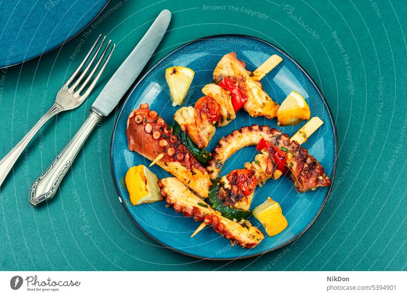 Seafood kebabs, octopus on skewers. grilled tentacle squid seafood grilled octopus octopus tentacle mollusc calamary shish kebab barbecue flat lay top view