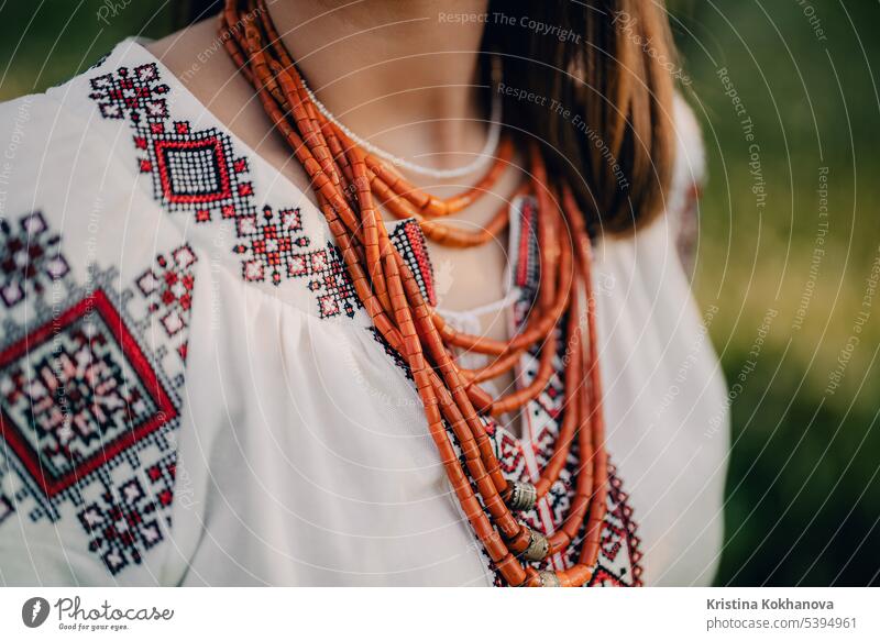 Ukrainian woman in embroidery vyshyvanka dress and ancient coral beads. abstract accessory attractive background beautiful beauty bijou bijouterie bracelet