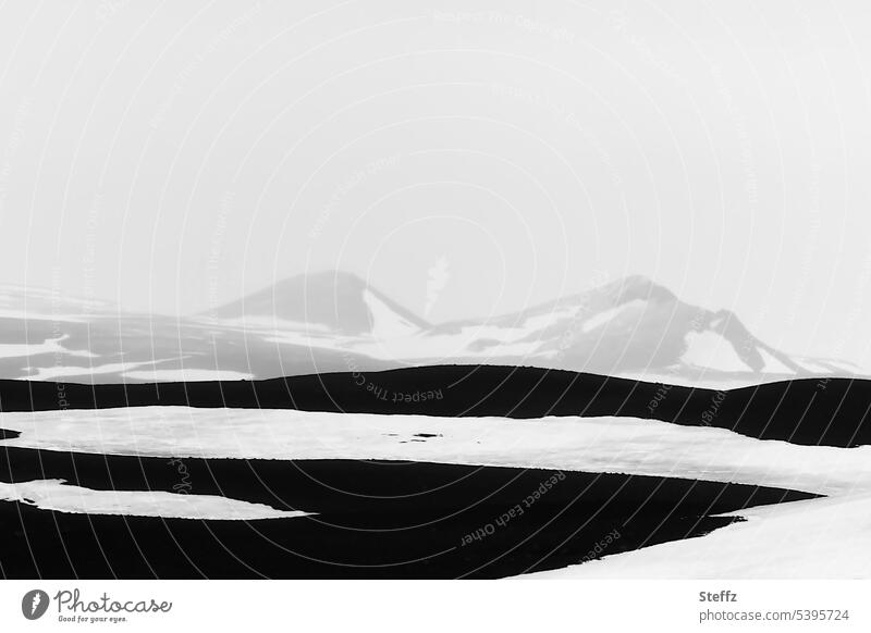 Snowy landscape with the mountains and hills in Iceland North Iceland Snow melt Abstract Cold rocky White Black black-and-white Lonely Gray Dark Mysterious