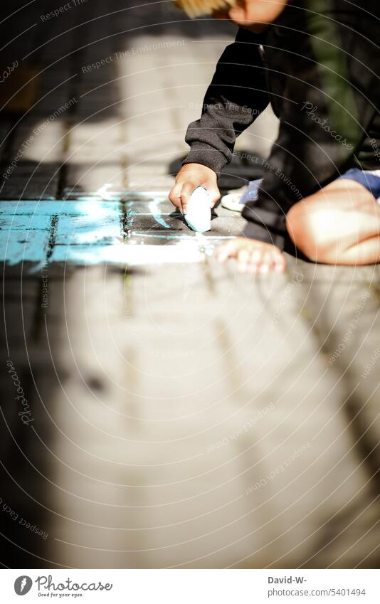 Child paints with chalk on the floor Creativity Chalk Painting (action, artwork) Ground Playing Street painting Infancy Art Hand fun Employment self-employment