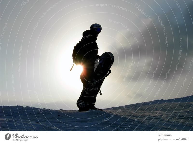 Hm, where do I have to go now? Snowboard Snowboarder Back-light Clouds Ski run Sun Exterior shot Carrying 1 Colour photo Silhouette Winter sun Winter sports