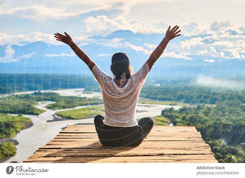 Unrecognizable woman enjoying freedom over wooden board on mountain traveler pier nature vacation arms raised lake trip admire picturesque sunset scenic journey