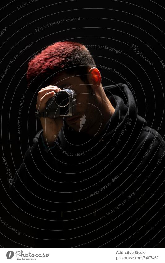 Anonymous young man taking shot on video camera shoot record using digital portrait gadget style modern amateur equipment vlog male device portable professional