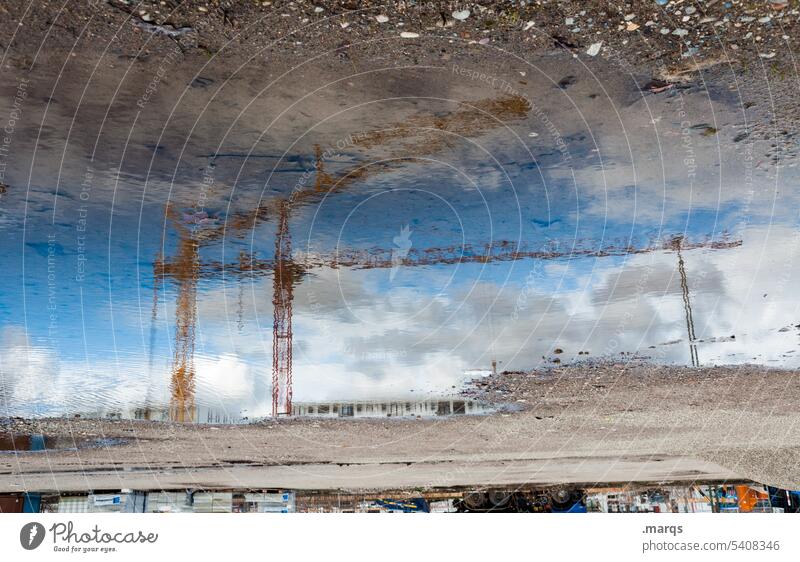 Cranes in puddle Reflection Puddle Construction site Sky Moody Industrial Photography Build Clouds Work and employment Economy Construction crane Change