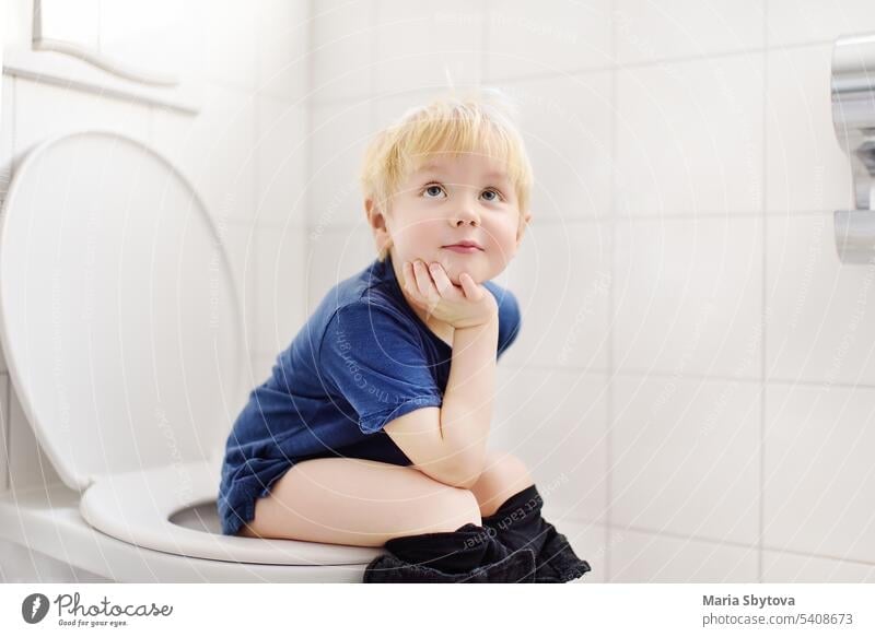 Cute little boy in restroom. Toddler child is training use toilet. Treatment of constipation of little kids. Teaching children of hygiene toilette potty