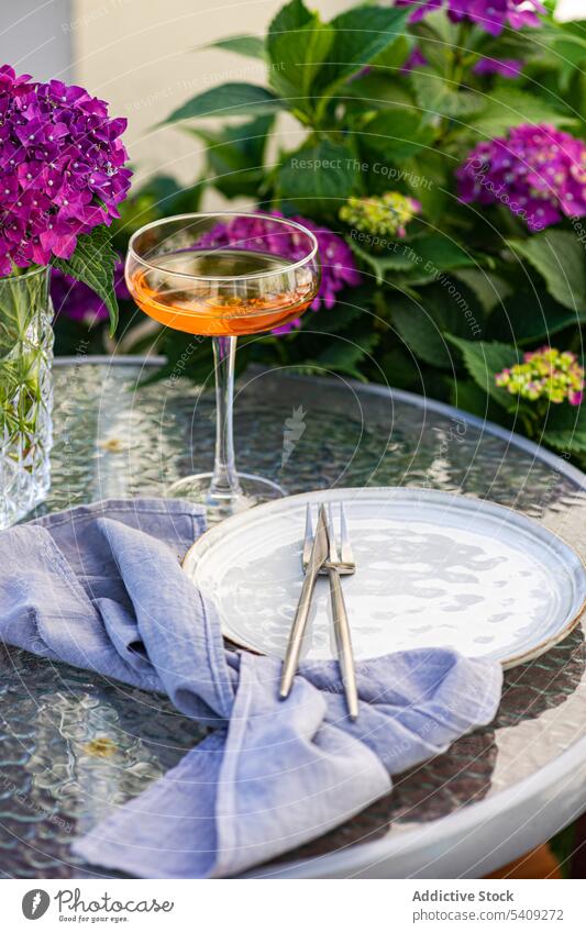Vase with flowers on table near plate vase bouquet hydrangea garden glass serve drink creative decor beverage ceramic purple design fresh plant natural