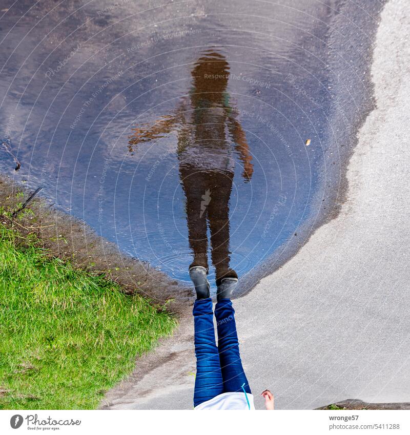 Everything that begins with Un | blurred mirror image topic day Mirror image reflection Surface of water Puddle Street Girl Child Reflection Water Day Asphalt