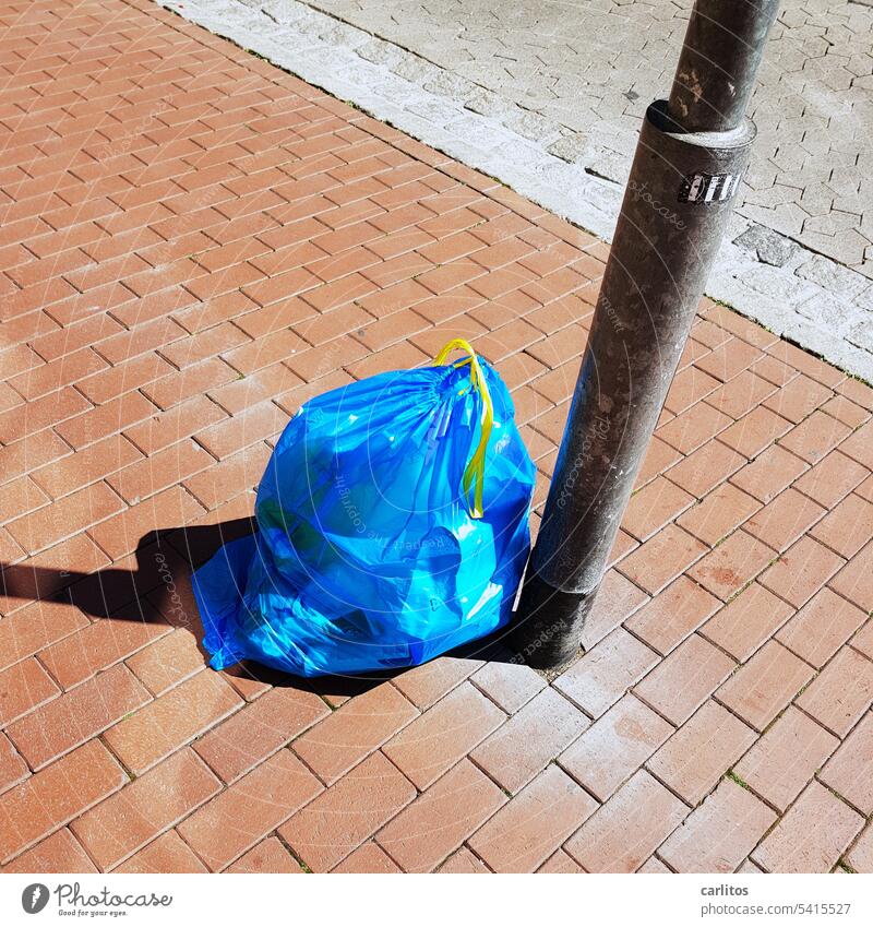 Collecting is the miller's delight | have the collected garbage in the bag Trash Garbage bag Blue Lantern pavement off downtown Pedestrian precinct Sidewalk