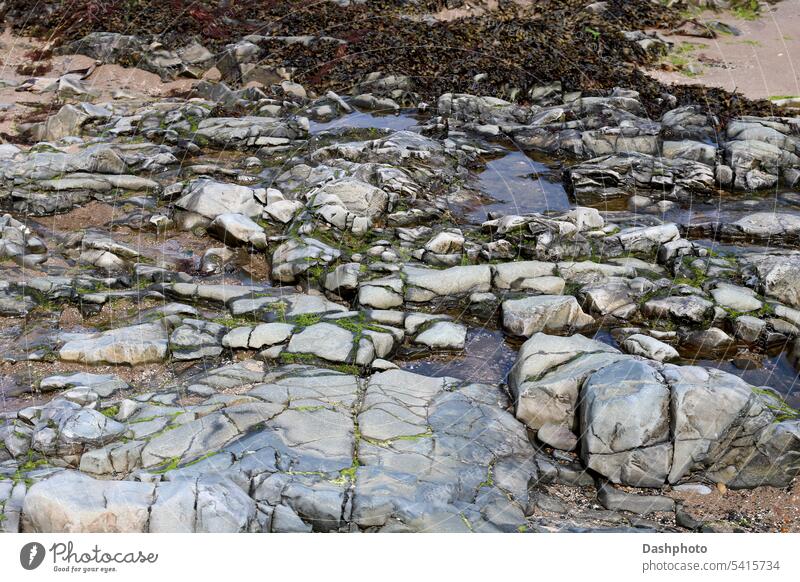 Volcanic Rock Formations with Rock Pools at a Coastal Location rock rocks volcanic volcanic rock coast coastal seaside oceanside water sea water rock pools