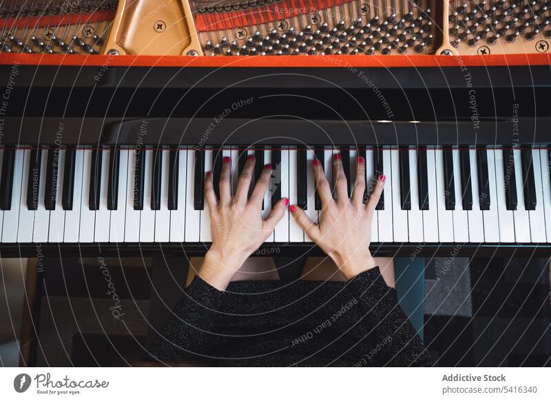 Top view of cropped hands playing the piano top view woman musician elegant room pianist instrument keyboard art sound performance melody classical harmony