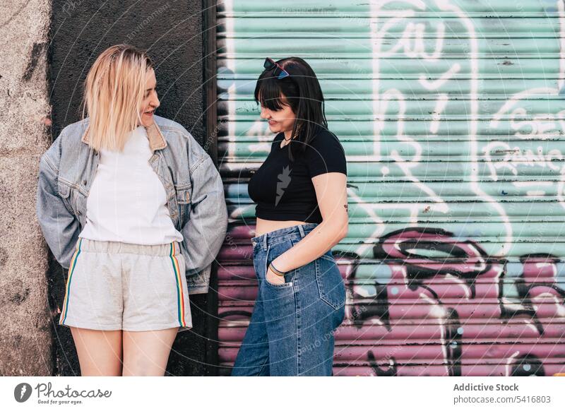Lesbian couple leaning in a wall on street lesbian lgbt happy city young together women casual homosexual pride equality alternative relationship love cheerful
