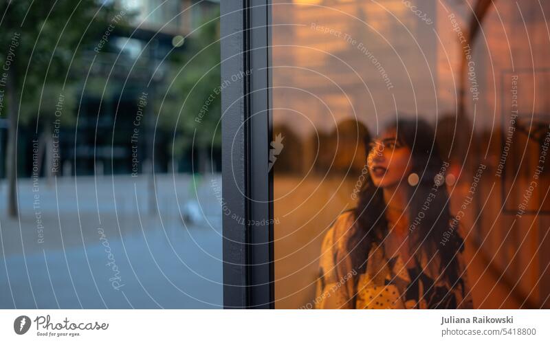 Woman in the city behind a window Modern Youth (Young adults) Summer Young woman Feminine naturally Brunette Dark hair Long-haired Authentic Style 18 - 30 years