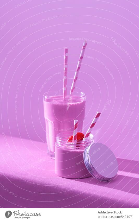 Yummy milkshake with fresh ripe strawberry on table in pink light dairy drink healthy diet super food refreshment vitamin glass detox beverage delicious fruit