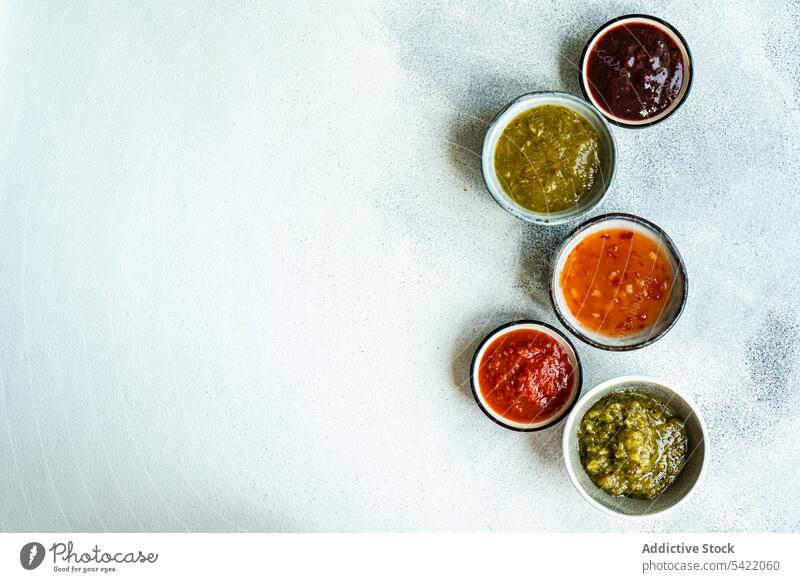 Bowls with traditional Georgian sauces: green plum Tkemali sauce, tomato and cilantro Satsebeli sauce, Kiwi satsebeli bowl ceramic georgian kiwi dish ingredient