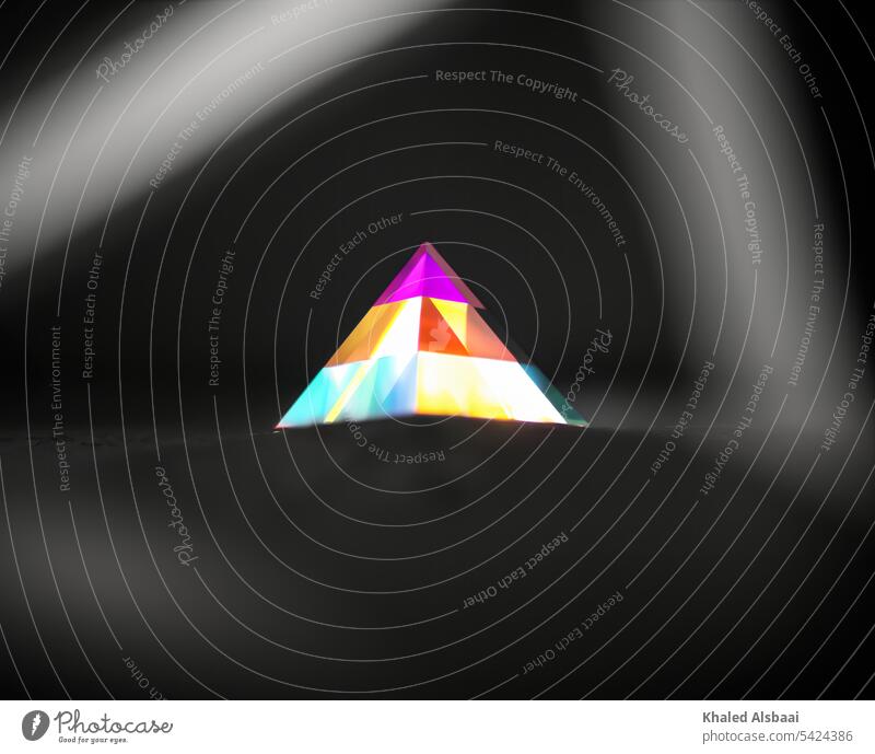 A group of colorful triangles create the shape of the pyramid - Artistic Abstract tranquility light rays beams background abstract shining bright glowing