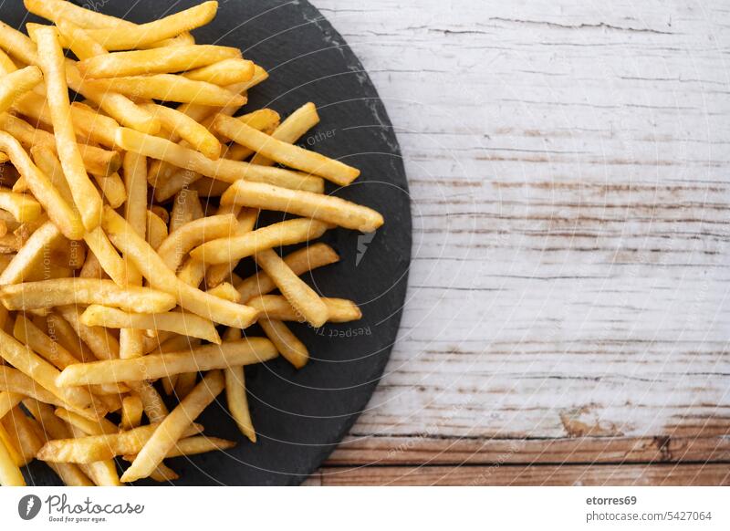 Fried potatoes, french fries on wooden table chips crispy crunchy dish fast fast food fried fry golden lunch nutrition plate salted snack unhealthy vegetable