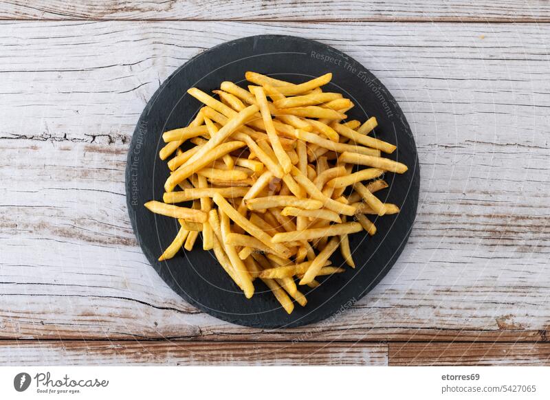 Fried potatoes, french fries on wooden table chips crispy crunchy dish fast fast food fried fry golden lunch nutrition plate salted snack unhealthy vegetable