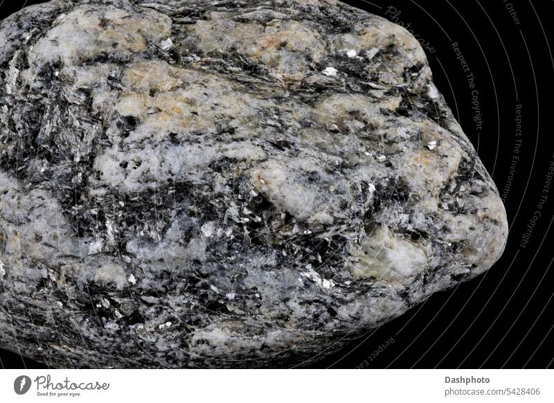 Piece of Granite Rock with Crystals Isolated Against a Black Background igneous igneous rock granite crystals quartz quartz crystals stone grey gray closeup