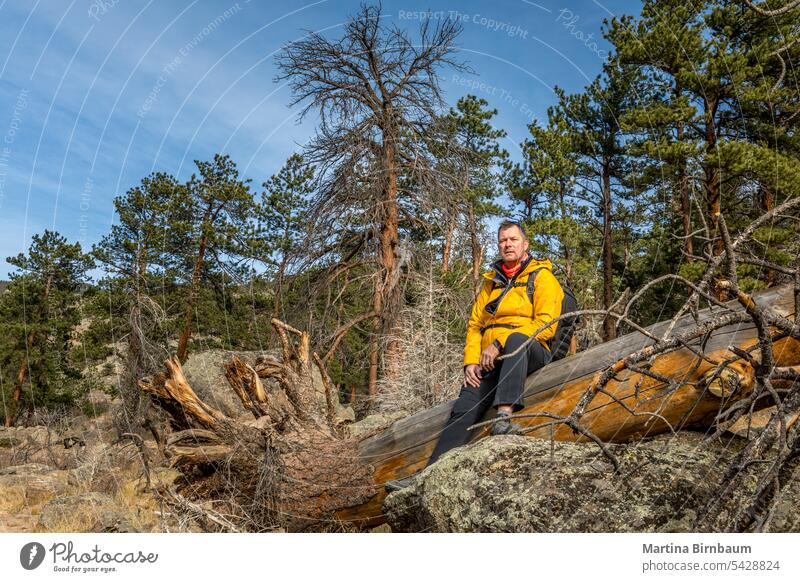 A 52 year old hiker having a break in the Rocky Mountains National Park, Colordo colorado rocky mountain national park outdoors hiking rest leisure man years