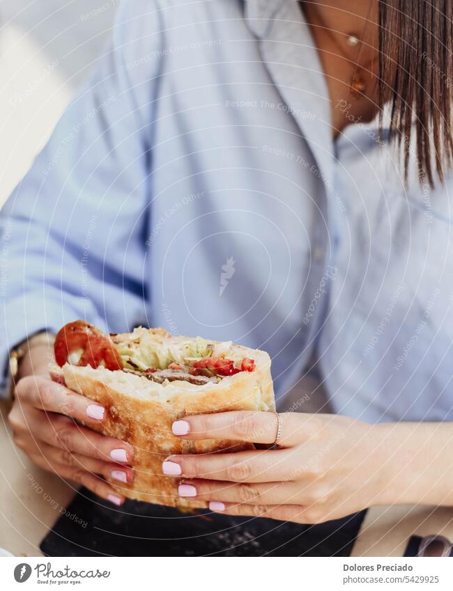 A young person enjoying a beef sandwich adult asian background bokeh bread breakfast bun burger calorie calories cheeseburger closeup delicious dinner eat