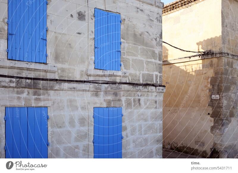 The blue of the south | Side street in Arles Manmade structures Street Old Historic window flaps Sun Stone architecture Electricity urban Cable Energy industry