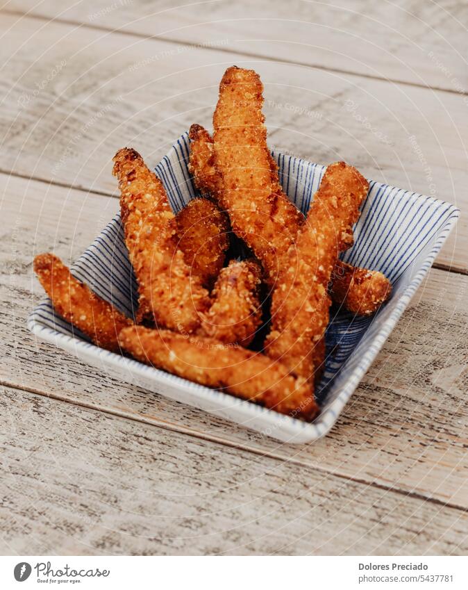 Serving of battered and fried chicken drumsticks appetizer background breaded cheese condiment cooking crispy crunchy cuisine deep delicious dinner dish fast